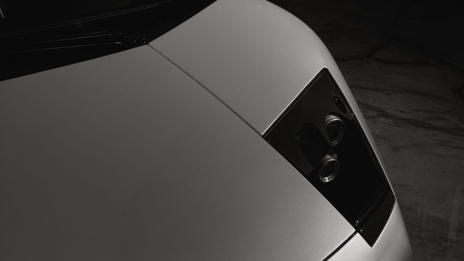 Close-up of a silver supercar headlight